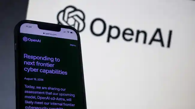 Smartphone showing OpenAI cyber capabilities news with OpenAI logo in the background